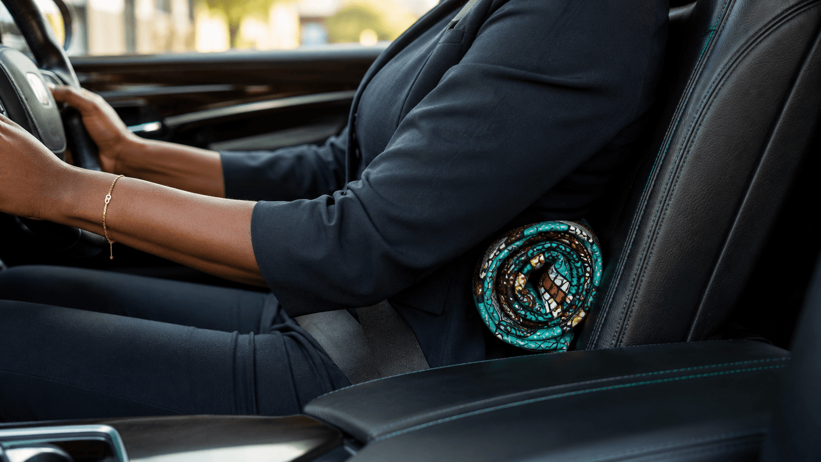 A professional in a corporate suit using an Ankara fabric roll for lumbar support—one of our top healthy lifestyle tips for office workers in Lagos